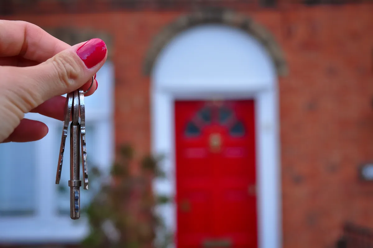 Couple reviewing paperwork on a laptop