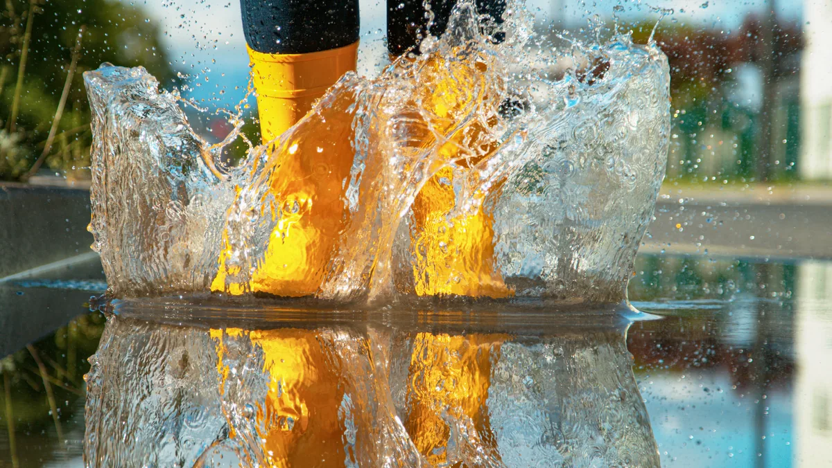 Yellow rain boots standing in floodwater